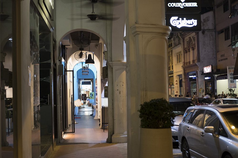 View from under the arched five-foot way of a shophouse looking along Purvis Street at night
